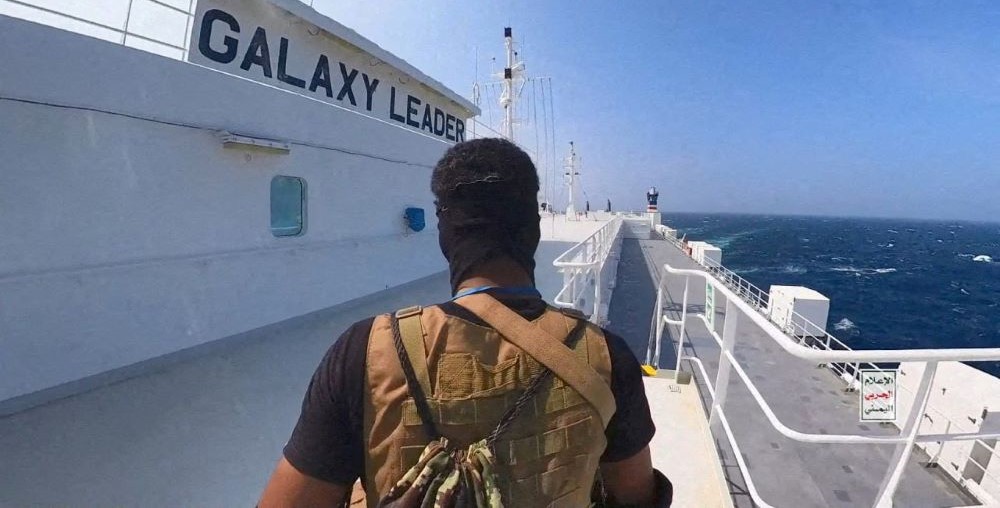 A Houthi fighter stands on the Galaxy Leader cargo ship in the Red Sea in this photo released Nov. 20, 2023. (Reuters)