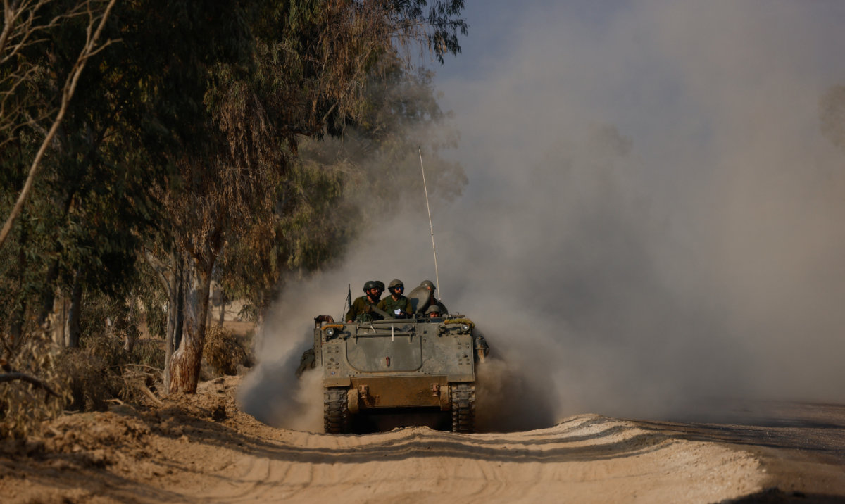 Israeli armoured personnel carrier (APC) maneuvers along the border with central Gaza, amid the ongoing conflict between Israel and the Palestinian Islamist group Hamas, in southern Israel, January 1, 2024. (Reuters)