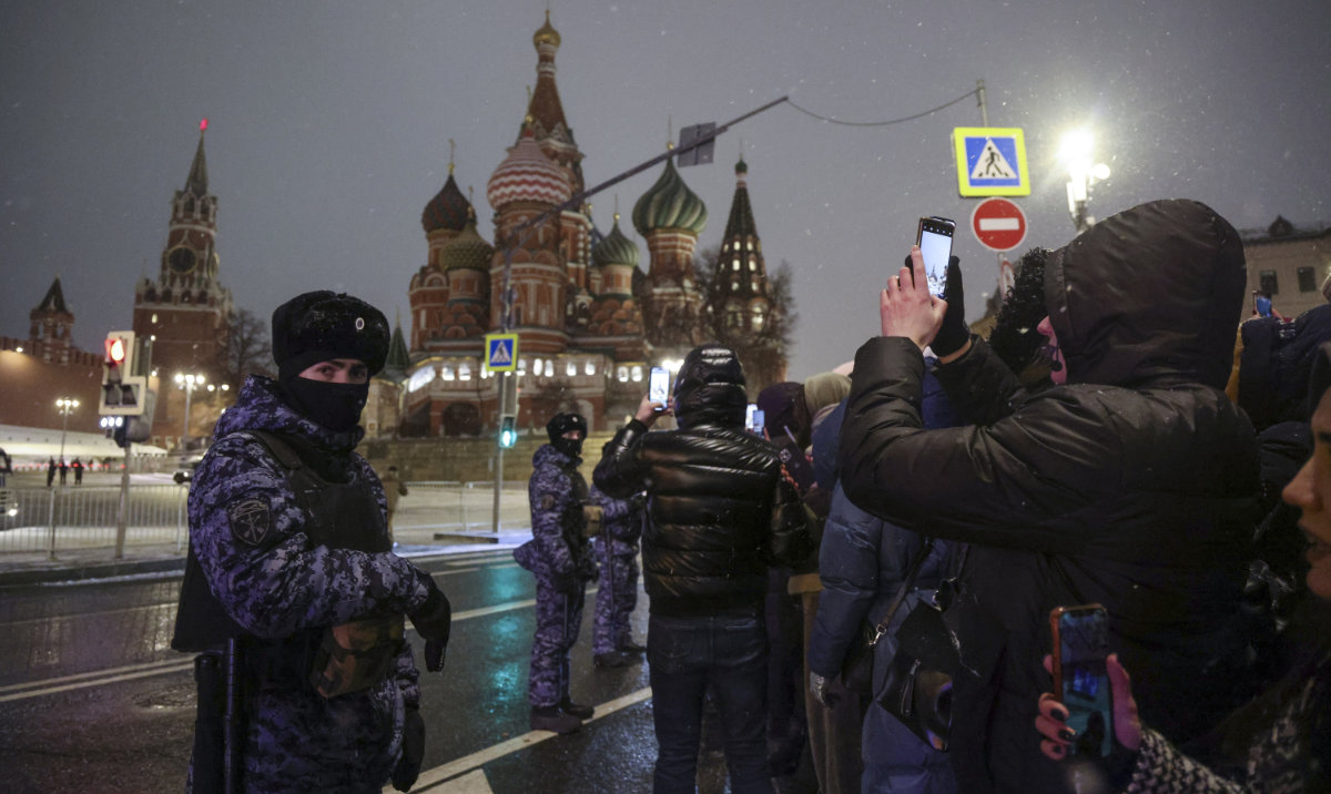 Police block people as they gather near Red Square with the St. Basil's Cathedral, right, and the Spasskaya Tower, left, in the background, to celebrate the new year after midnight in Moscow, Russia, Monday, Jan. 1, 2024. (AP)