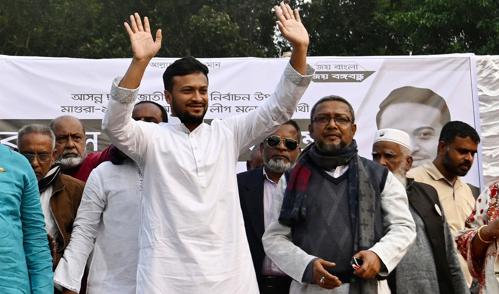 In this photograph taken on December 27, 2023, Shakib Al Hasan (C), national cricket team captain and election candidate of the ruling Bangladesh Awami League, waves to supporters during a campaign rally ahead of the 2024 general elections, in Magura, Bangladesh. (AFP)