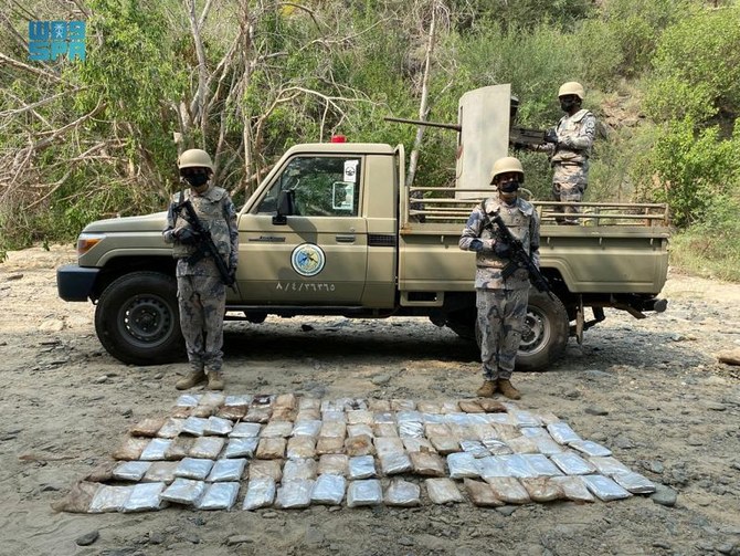 Saudi Border Guard troopers display the packs of qat they have confiscated from smugglers. (SPA)