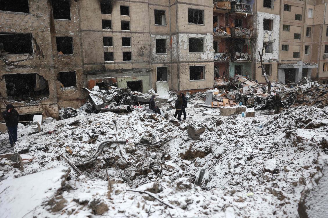 Police officers and local residents inspect damage outside a destroyed high-rise building following a Russian missile attack in central Kyiv amid the Russian invasion of Ukraine. (AFP)