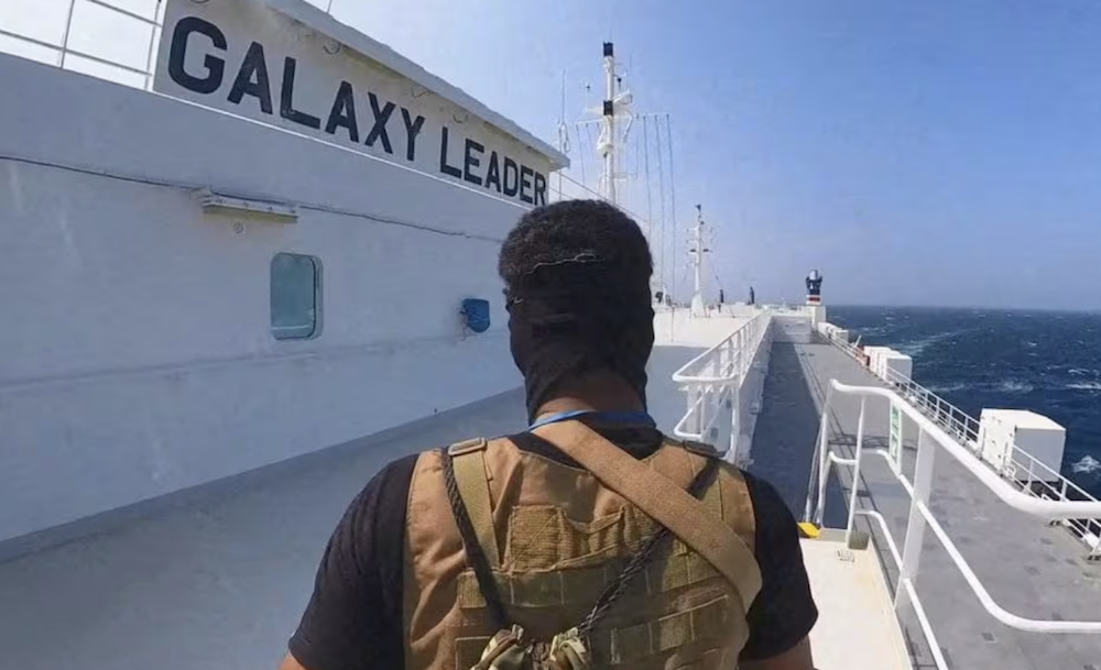 A Houthi fighter stands on the Galaxy Leader cargo ship in the Red Sea in this photo released November 20, 2023. (Houthi Military Media via Reuters)