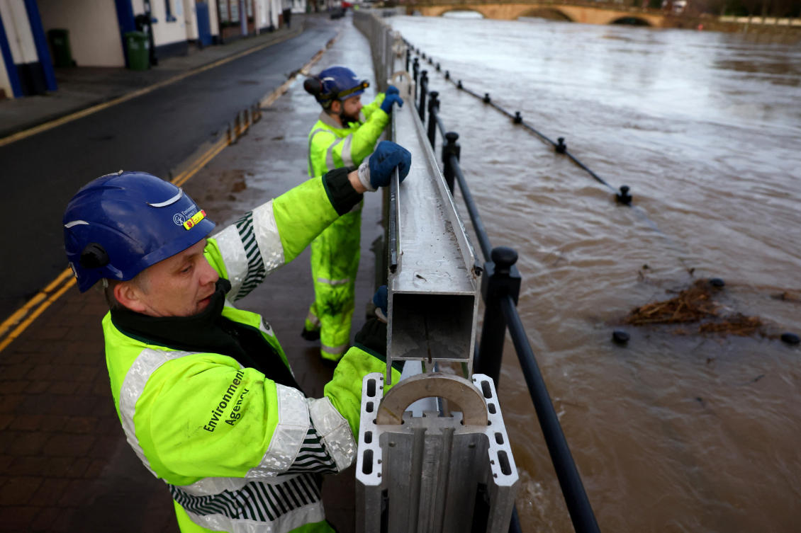 Environment Agency workers have been reinforcing the flood barriers along the River Severn after heavy rain from Storm Henk.(REUTERS)