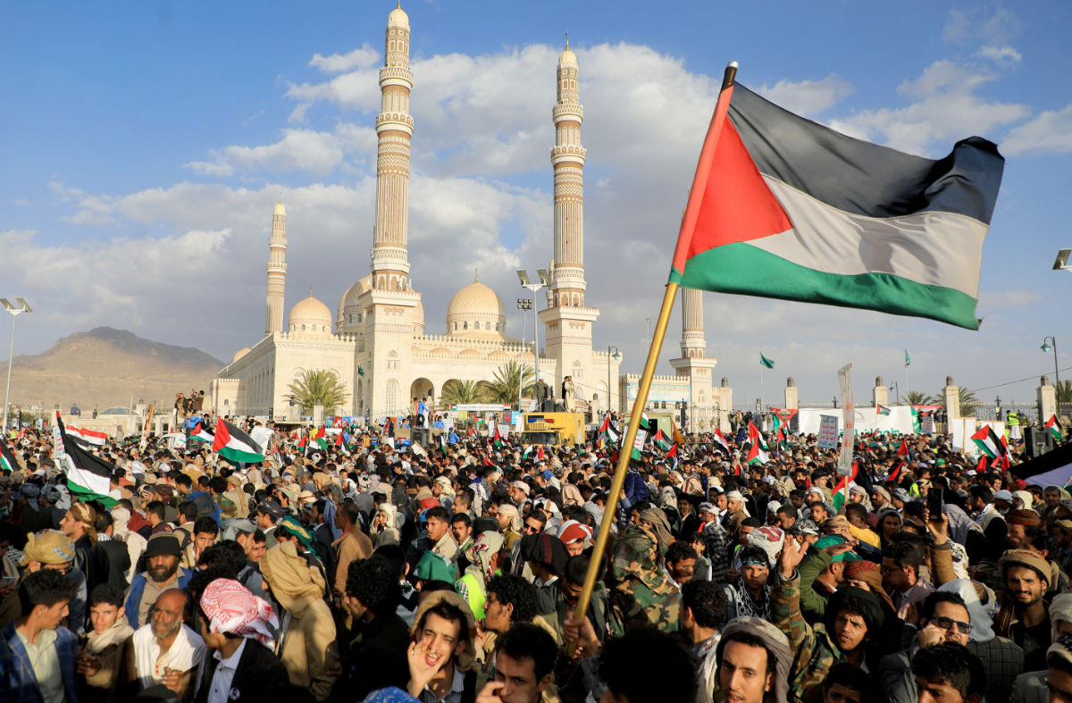 Demonstrators, one holding a Palestinian flag, take part in a march in solidarity with the people of Gaza in the Huthi-controlled capital Sanaa on January 5, 2024 amid the ongoing battles between Israel and the militant Hamas group in Gaza. (AFP)