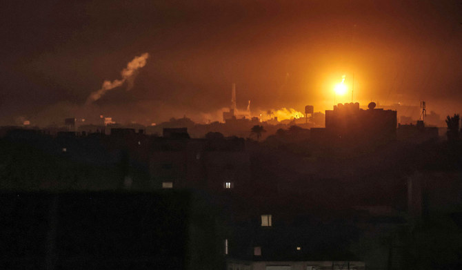Israeli bombardment lights the skyline of Khan Yunis, pictured from Rafah in the southern Gaza Strip late on January 7, 2024.(AFP)