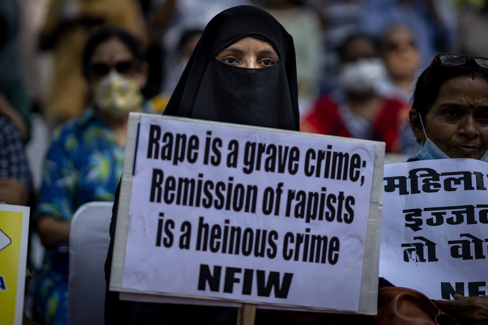 In this file photo, a woman holds a placard during a protest in New Delhi, India on Aug. 27, 2022. (AP)