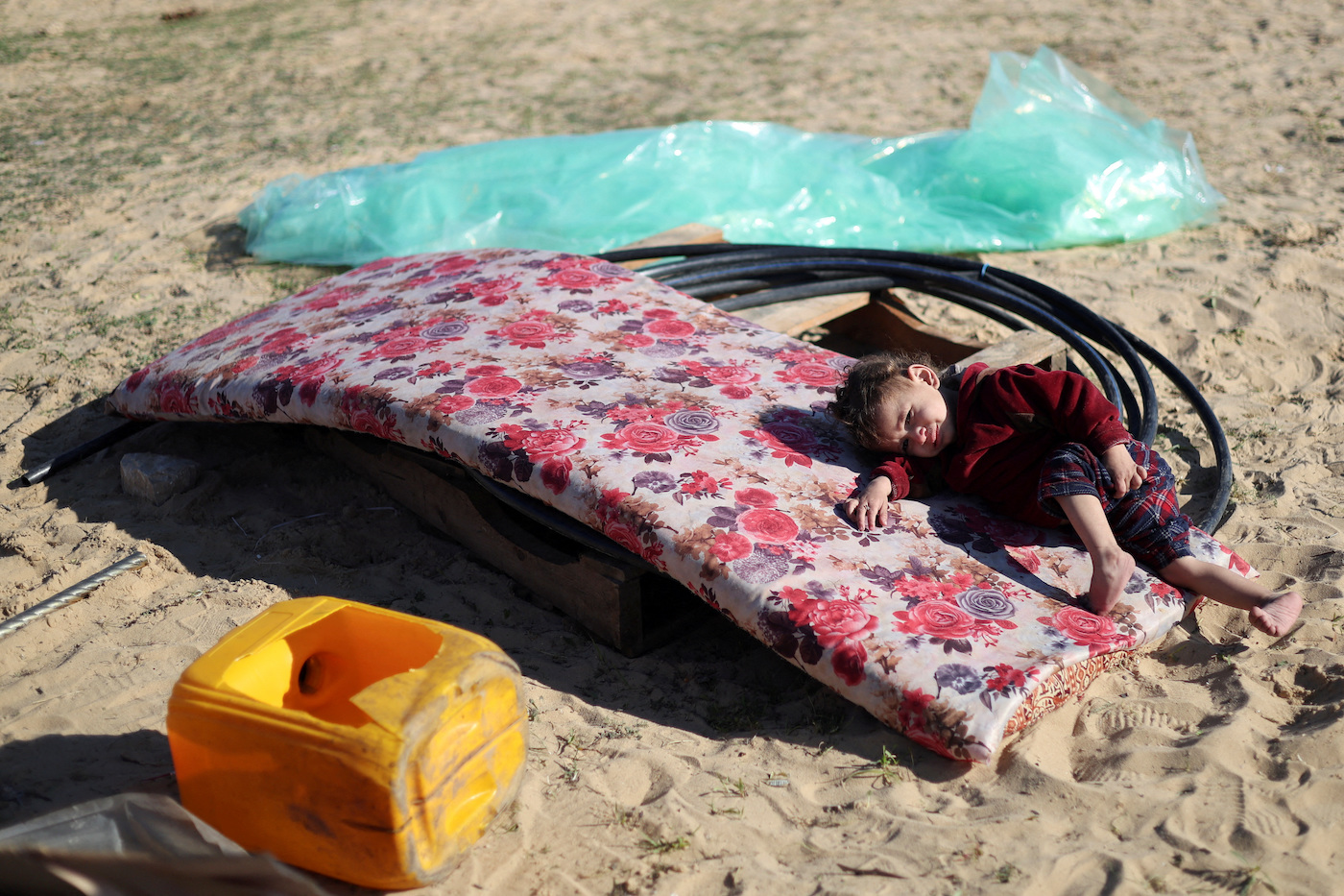 A displaced Palestinian child, who fled from home due to Israeli strikes, is seen near the border with Egypt, in Rafah in the southern Gaza Strip, Jan. 7, 2024. (Reuters)