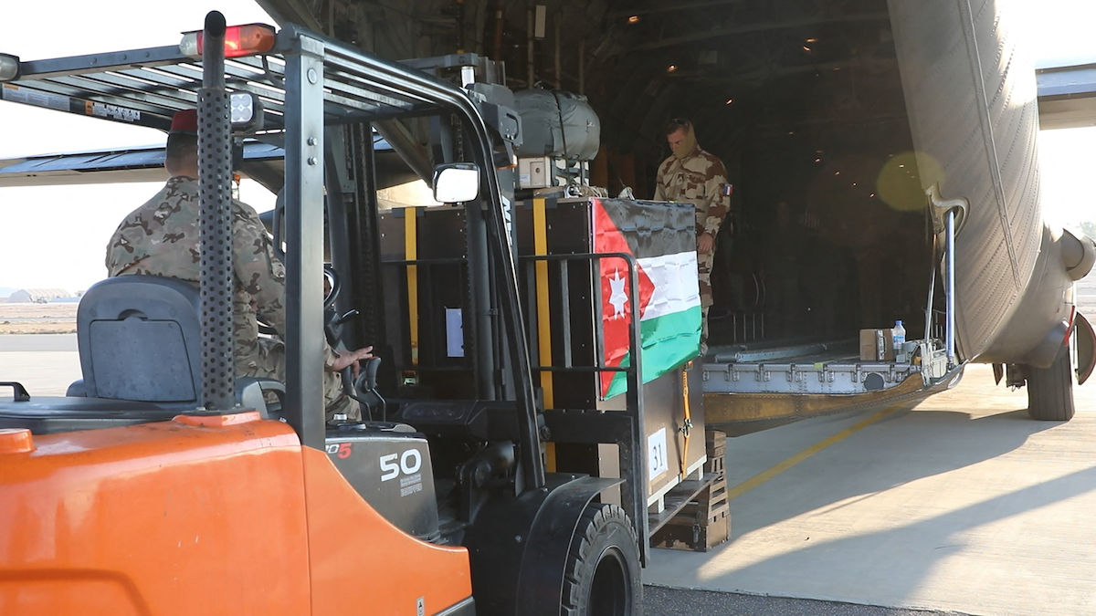 Boxes of French-Jordanian humanitarian aid being loaded into a military cargo plane at an undisclosed location in Jordan before airdrops over Gaza Strip. (File/AFP)