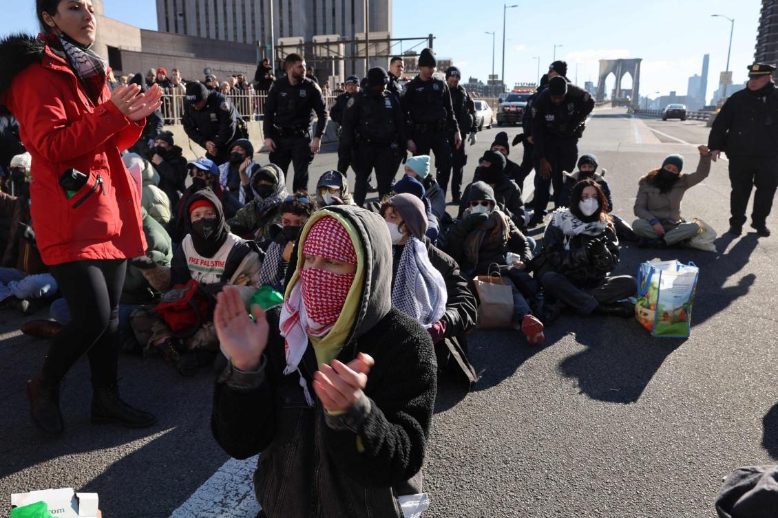 Pro-Palestinian demonstrators close down the Brooklyn Bridge, one of the main bridges connecting Manhattan to Brooklyn, on Monday morning on January 08, 2024 in New York City. (AFP)