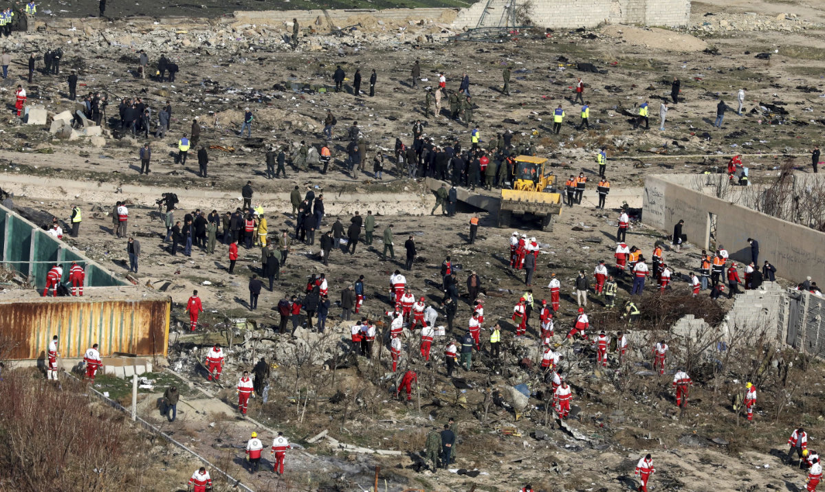 Rescue workers search the scene where an Ukrainian plane crashed in Shahedshahr, southwest of the capital Tehran, Iran. (AP/File)