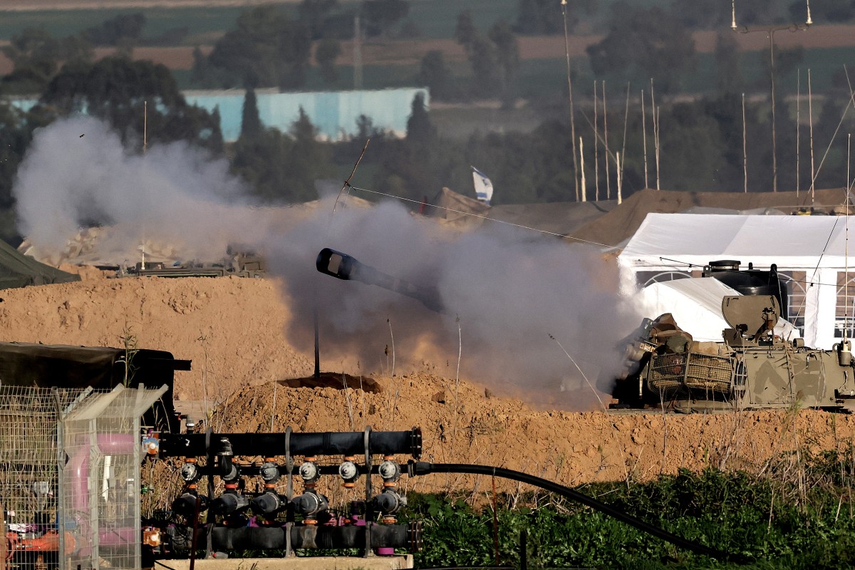 An Israeli army self-propelled artillery howitzers fire a round towards the Gaza Strip from a position near the border in southern Israel (AFP)