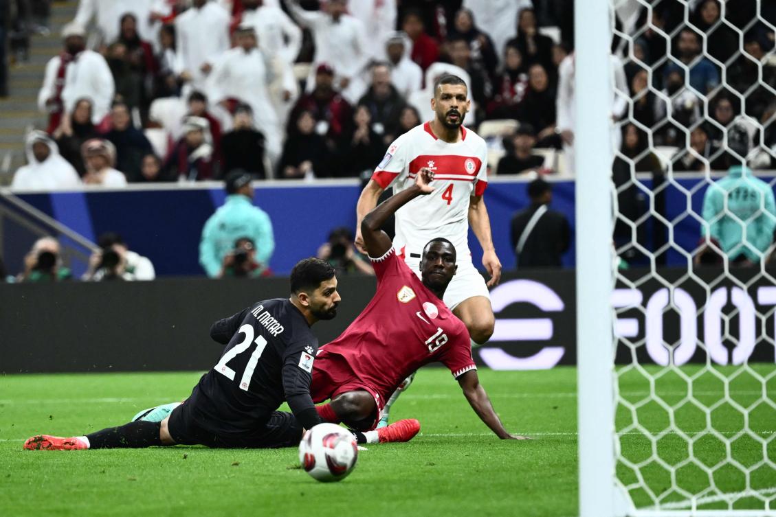 Qatar’s forward Almoez Ali shoots to score a goal past Lebanon’s goalkeeper Mostafa Matar, which was later disallowed, during their AFC Qatar 2023 Asian Cup Group A match at the Lusail Stadium in Lusail on Jan. 12, 2024. (AFP)