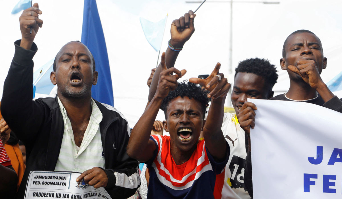 Demonstrators march against the Ethiopia-Somaliland port deal along a main street in Mogadishu, Somalia, amid growing tension in the region. (Reuters)