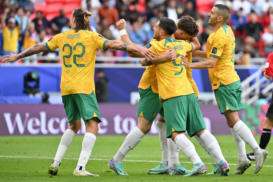 Australia’s defender Jordan Bos celebrates with teammates after scoring his team’s second goal during their Qatar 2023 AFC Asian Cup Group B match against India at the Ahmad bin Ali Stadium in Al-Rayyan on Jan. 13, 2024. (AFP)
