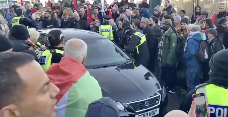 A woman was arrested and charged on Saturday after driving her car through a crowd of pro-Palestinian protesters in the center of Edinburgh. (Screenshot)