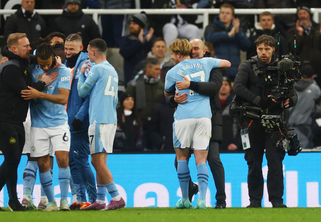 Manchester City manager Pep Guardiola celebrates with Kevin De Bruyne after their Premier League match against Newcastle United at St. James’ Park, Newcastle, on Jan. 13, 2024. (Reuters)