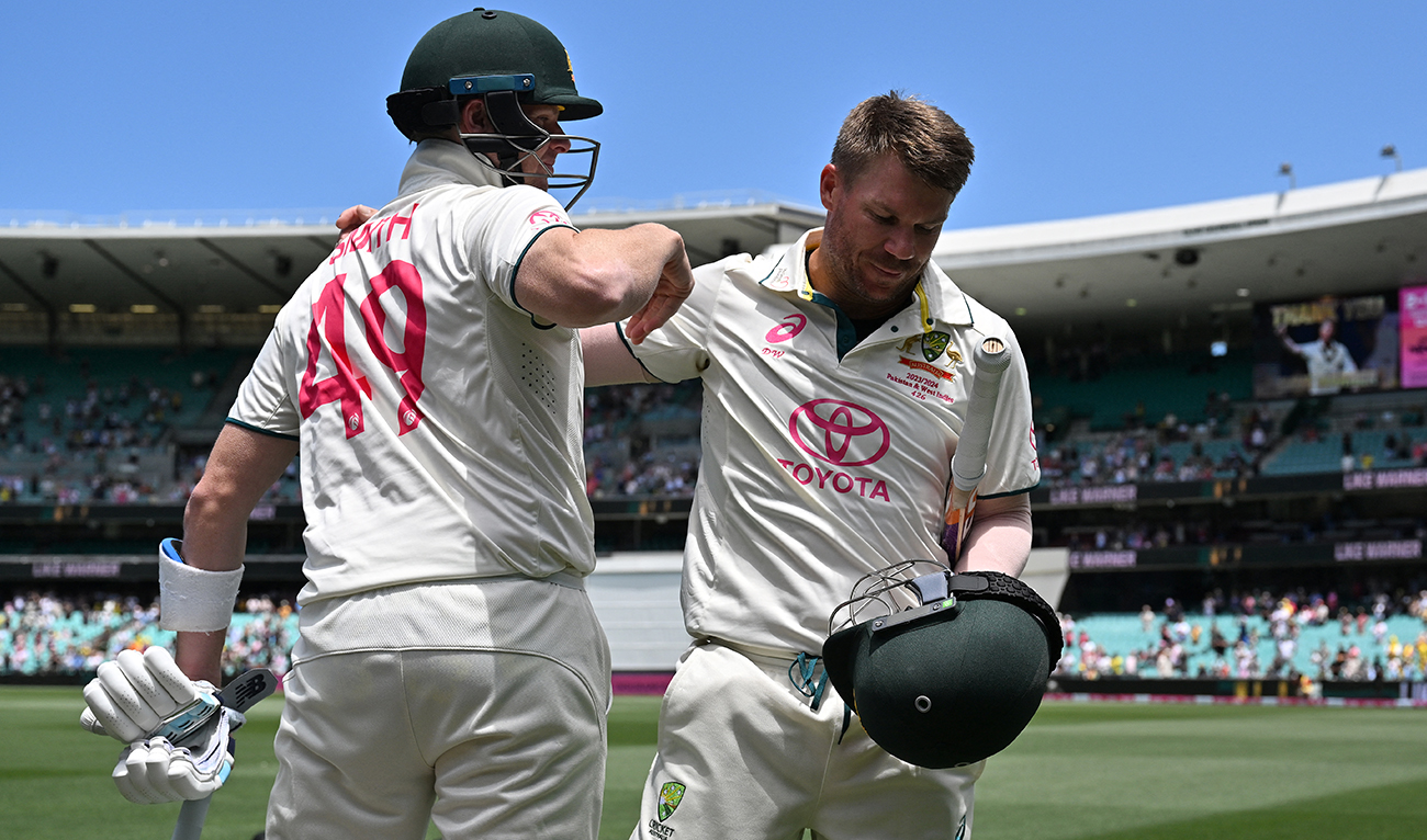Australia’s Steve Smith (L) hugs teammate David Warner who walks out after dismissal for the last time in his 112th and farewell Test on day four of the third cricket Test match between Australia and Pakistan at the Sydney Cricket Ground in Sydney on January 6, 2024. (AFP)