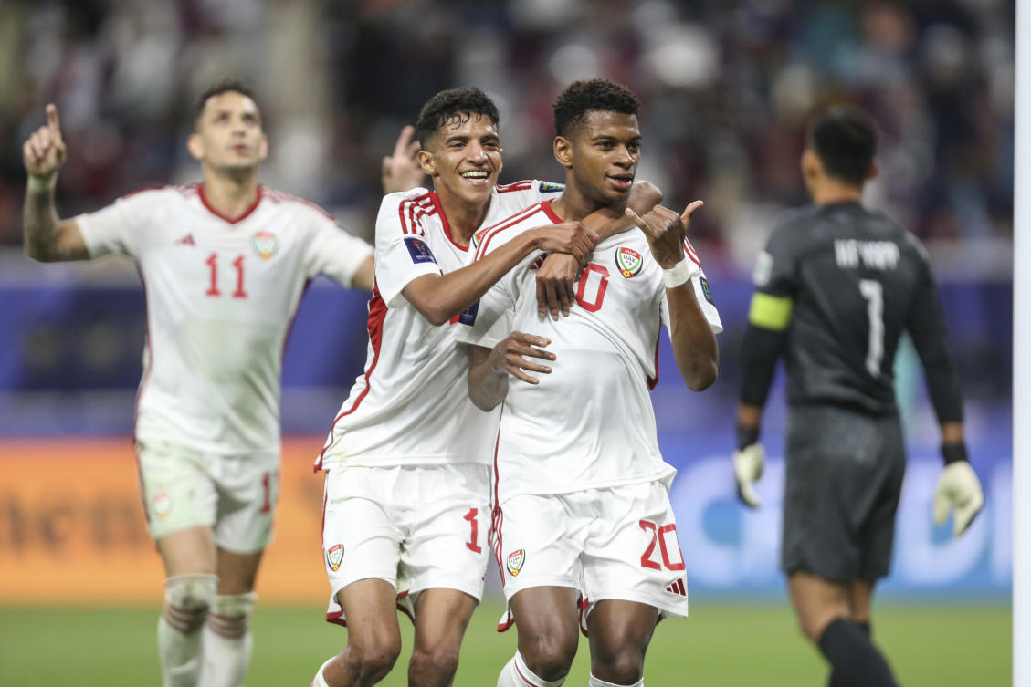 UAE’s Abdulla Hamad Almenhali, centre, congratulates his teammate Yahya Ali Alghassani, right, after he scored a goal during the Asian Cup Group C soccer match in Doha, Qatar, Jan. 14, 2024. (AP)