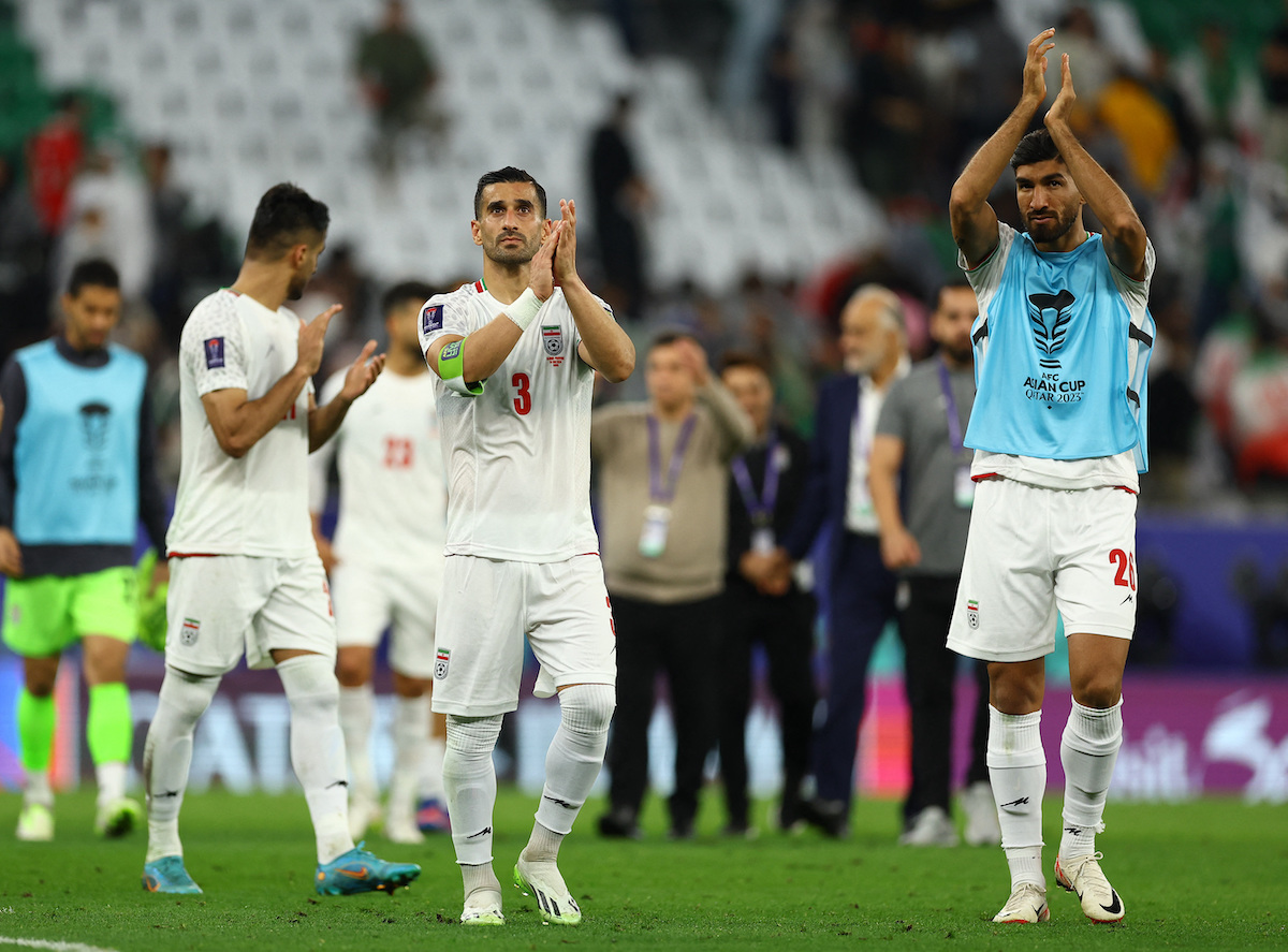Iran’s Ehsan Hajsafi and Shahriar Moghanlou celebrate after the match. (Reuters)
