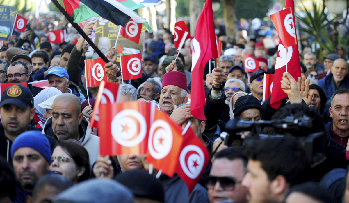 People commemorate the 13th anniversary of the Tunisian uprising in Avenue Habib Bourguiba, Tunis, Sunday, Jan. 14, 2024. (AP)