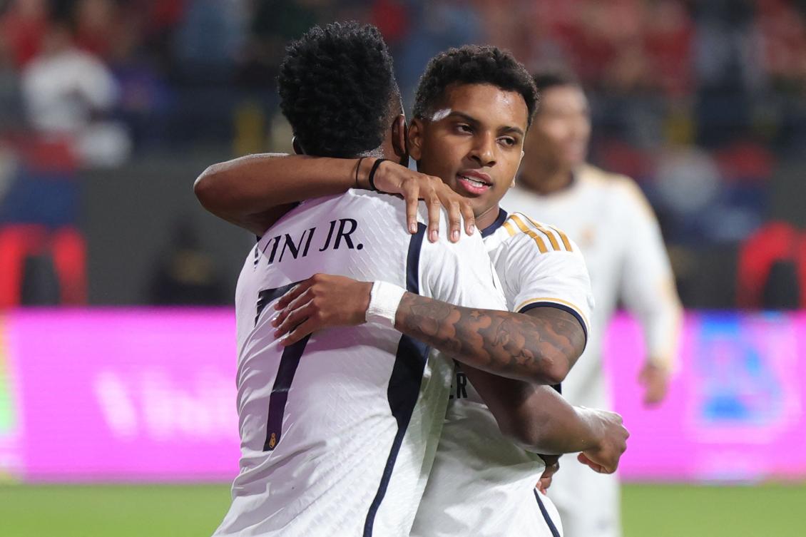 Real Madrid's Brazilian forward Vinicius Junior congratulates teammate Brazilian forward Rodrygo after the latter scored their fourth goal during the Spanish Super Cup final between Real Madrid and Barcelona on Jan. 14, 2024. (AFP)