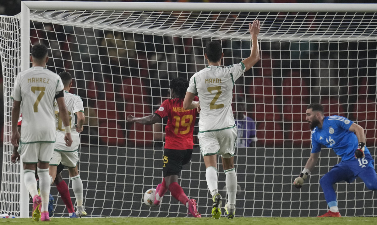 Angola's Mabululu, 3rd left, scores his side's goal after a rebound from a penalty kick during the African Cup of Nations Group D soccer match between Algeria and Angola in Bouake, Ivory Coast, Monday. (AP)