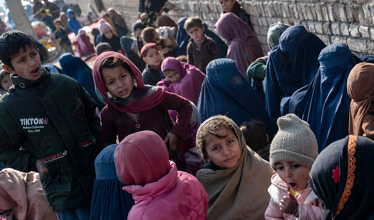 This photograph taken on January 9, 2024 shows Afghan burqa-clad women and children refugees deported from Pakistan, at the United Nations High Commissioner for Refugees (UNHCR) camp on the outskirts of Kabul. (AFP)