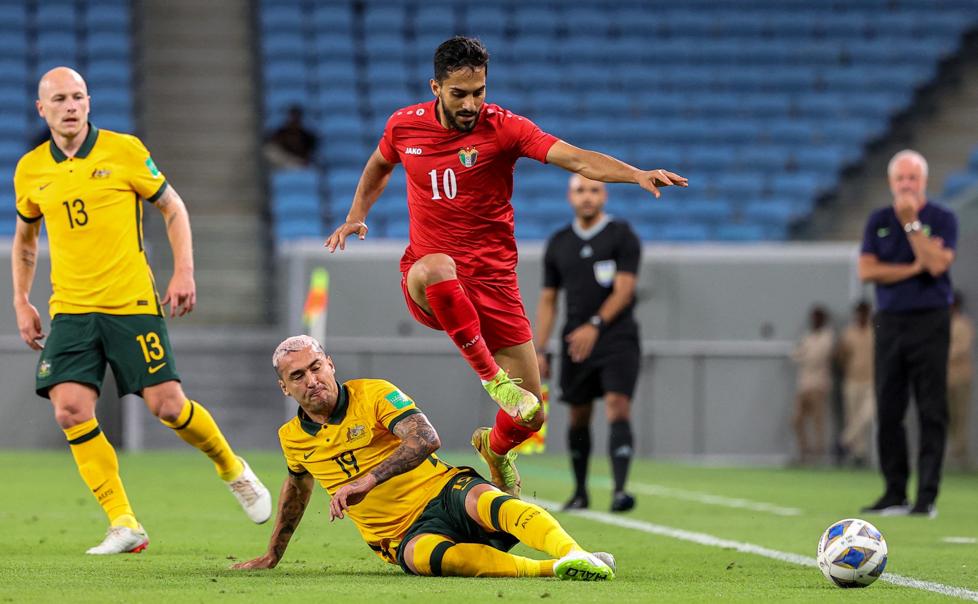 Australia's midfielder Gianni Stensness (Bottom) vies for the ball against Jordan's forward Musa Al-Taamari (Top) during the friendly match between Australia and Jordan at al-Janoub Stadium in Qatar's capital Doha on June 1, 2022. (AFP)