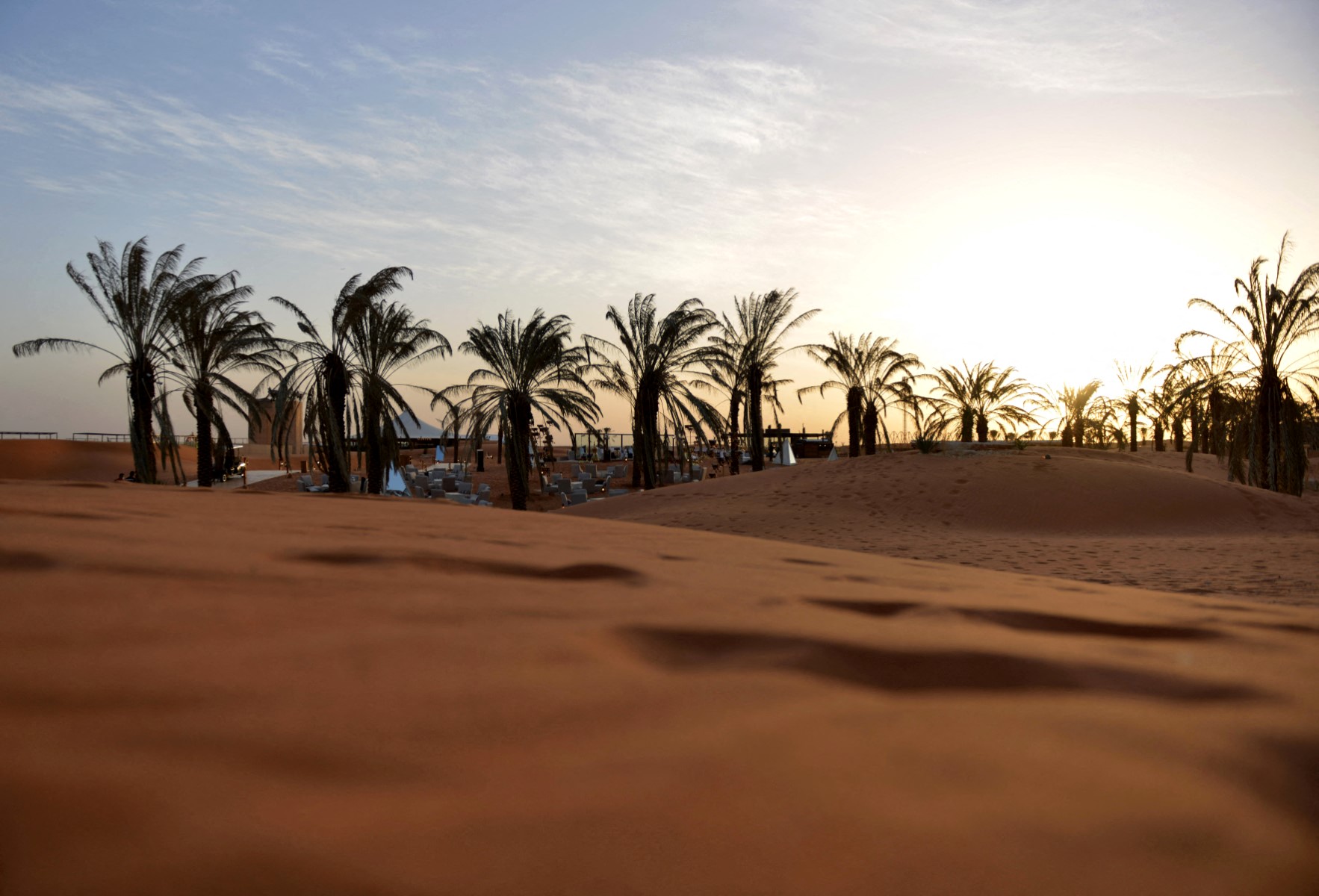 A picture taken on February 1, 2021, shows a lounge area beneath palm trees amid rolling dunes at the "Riyadh Oasis", a luxury retreat in the Thumamah desert on the outskirts of the Saudi capital. (AFP)