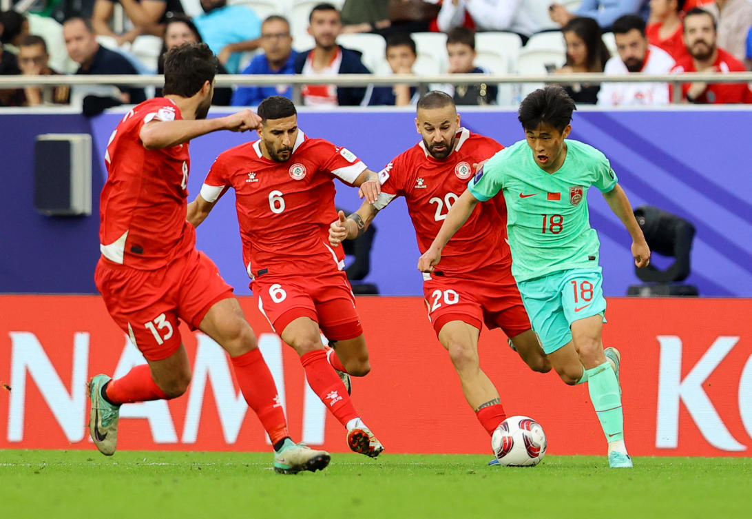 China’s Dai Wai-Tsun in action with Lebanon’s Hussein Zein, Ali Tneich and Khalil Khamis during their AFC Asian Cup — Group A — match at Al Thumama Stadium, Doha, on Jan. 17, 2024. (Reuters)