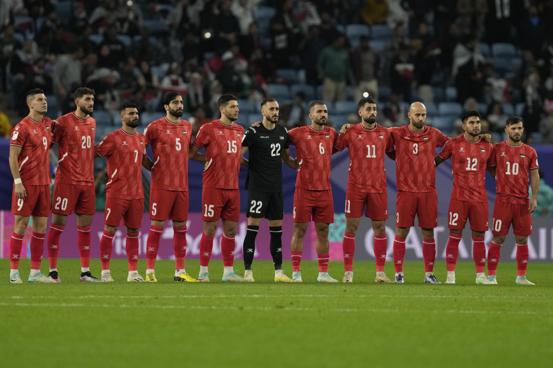 Palestinian players observe a moment’s silence prior to the start of the Asian Cup Group C game against the UAE at Al-Janoub Stadium, Al-Wakrah, Qatar, Thursday, Jan. 18, 2024. (AP Photo)