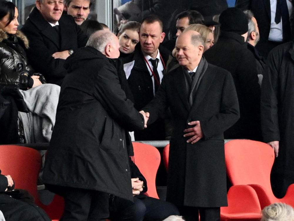 German Chancellor Olaf Scholz shakes hands with former president of Bayern Munich Uli Hoeness during the commemoration of Franz Beckenbauer hosted at Allianz Arena, Munich, on Jan. 19, 2024. (Reuters)
