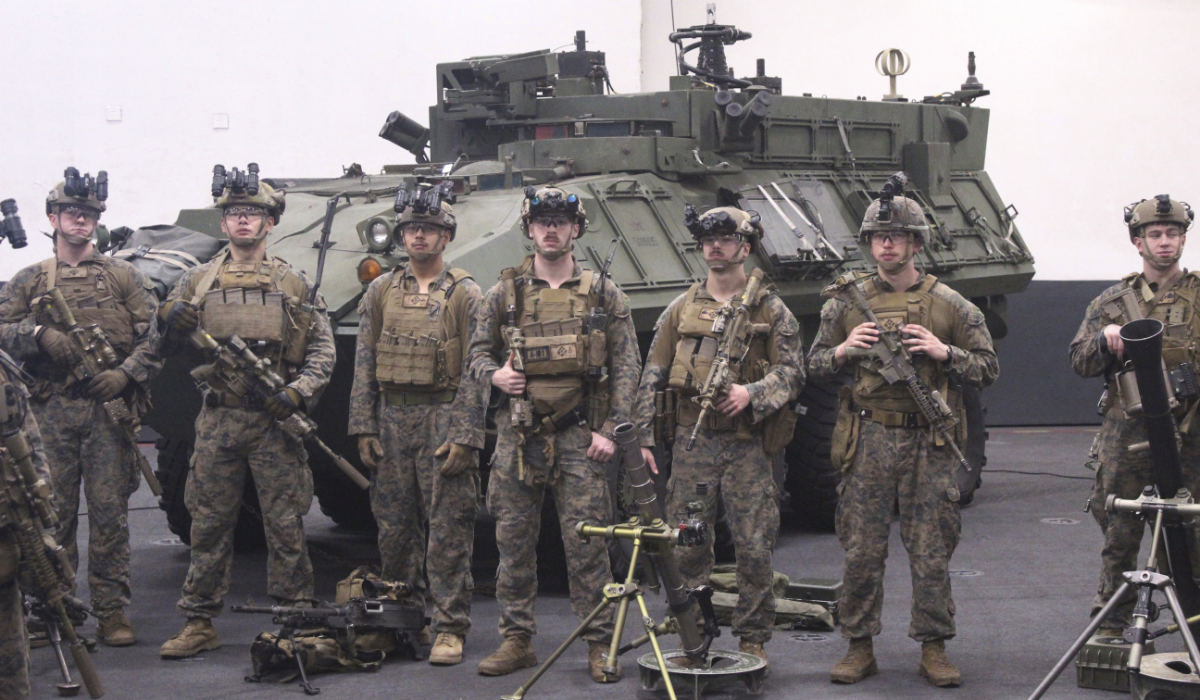 Infantry Marines from the 26th Expeditionary Unit stand next to an armored vehicle on the USS Bataan in the Aegean Sea, Greece. (AP)