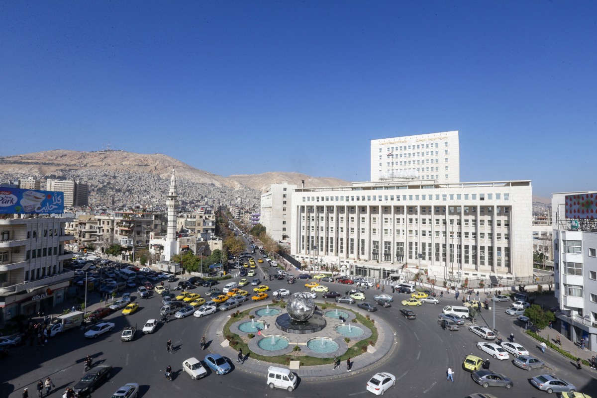 This picture shows a general view of Sabaa Bahrat Square with the central bank of Syria building (R) and Mount Qasioun seen in the background in Syria's capital Damascus on January 9, 2024. (AFP)