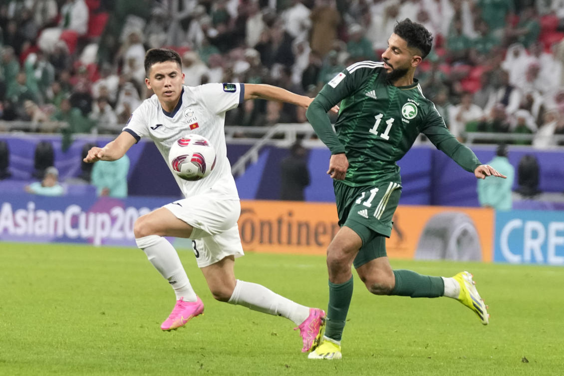 Saudi Arabia’s Saleh Alshehri, right, and Kyrgyzstan’s Stalbekov Nurdoolot fight for the ball during the Asian Cup Group F soccer match between Kyrgyzstan and Saudi Arabia at Ahmad Bin Ali Stadium, in Doha, Qatar, Sunday, Jan. 21, 2024. (AP)