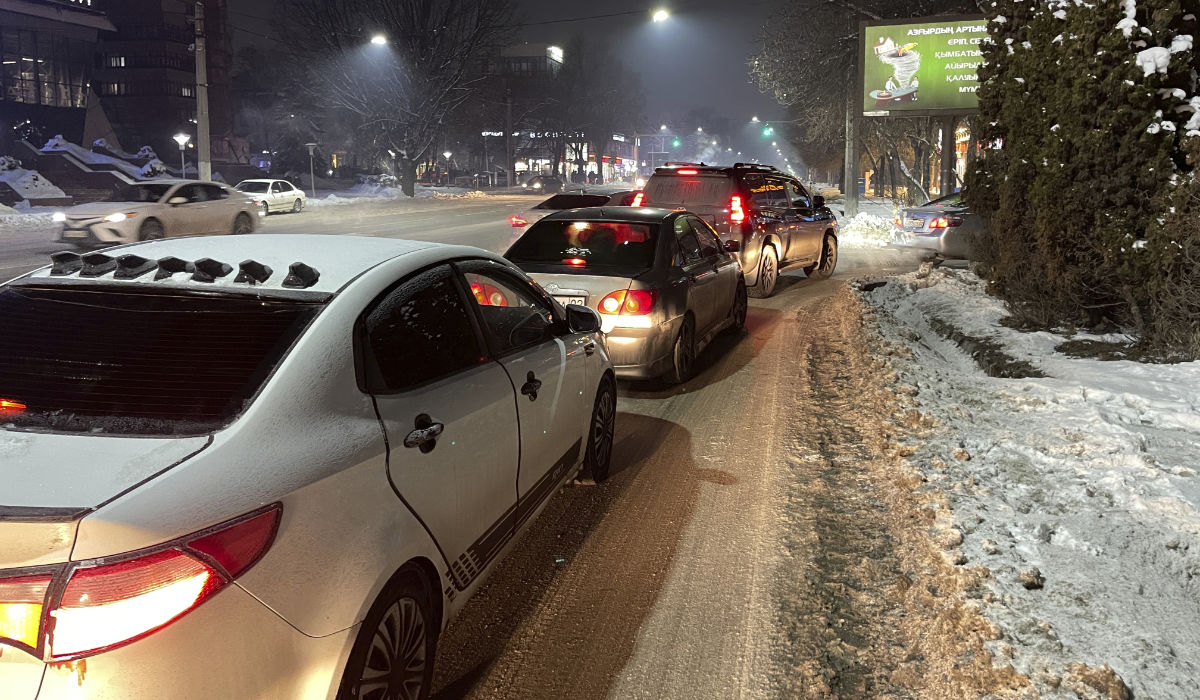 People sit inside their cars parked in a street after leaving their flats in apartment buildings after the earthquake in Almaty, Kazakhstan, Monday, Jan. 22, 2024. (AP)