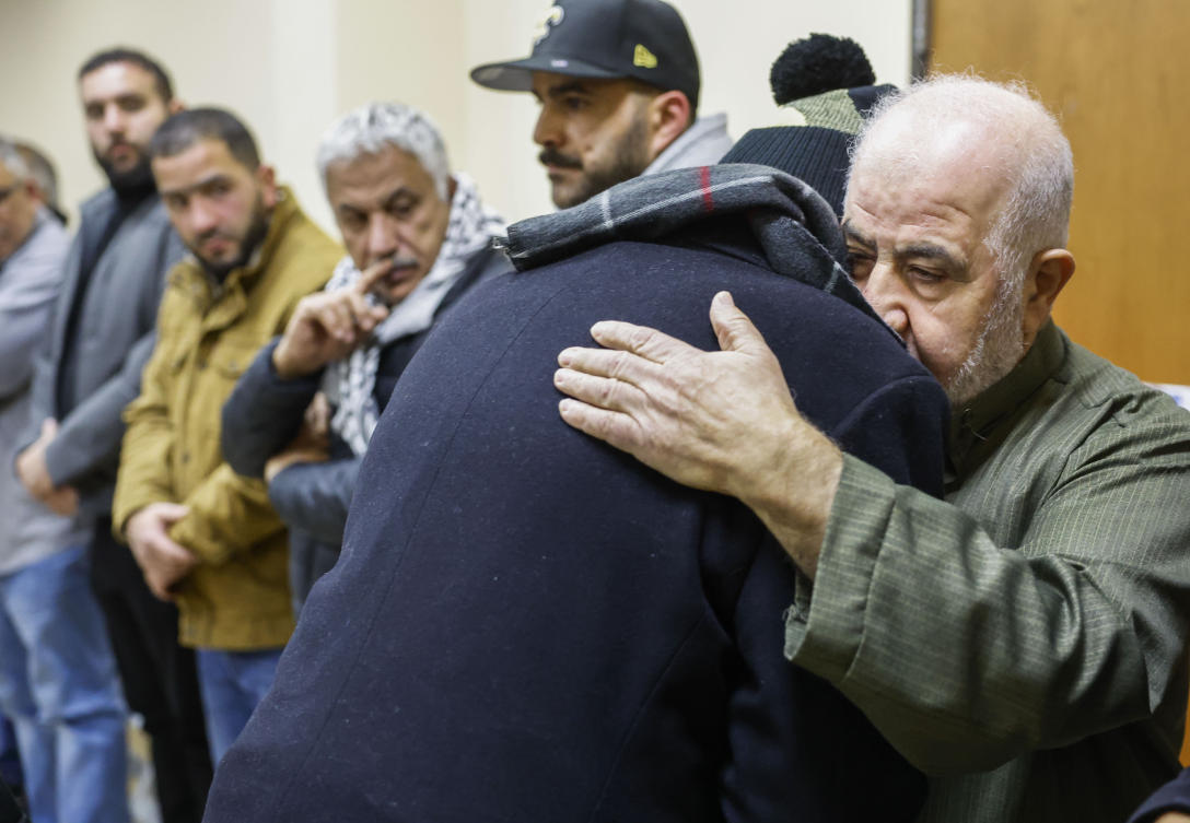 Abdelrehim Hamed hugs Mohammad Salem during the reception for his great-grandson Palestinian-American teenager Tawfiq Ajaq, 17, who was killed Friday by Israeli fire in the occupied West Bank, at Masjid Omar mosque in Harvey, La., Saturday, Jan. 20, 2024. (AP)