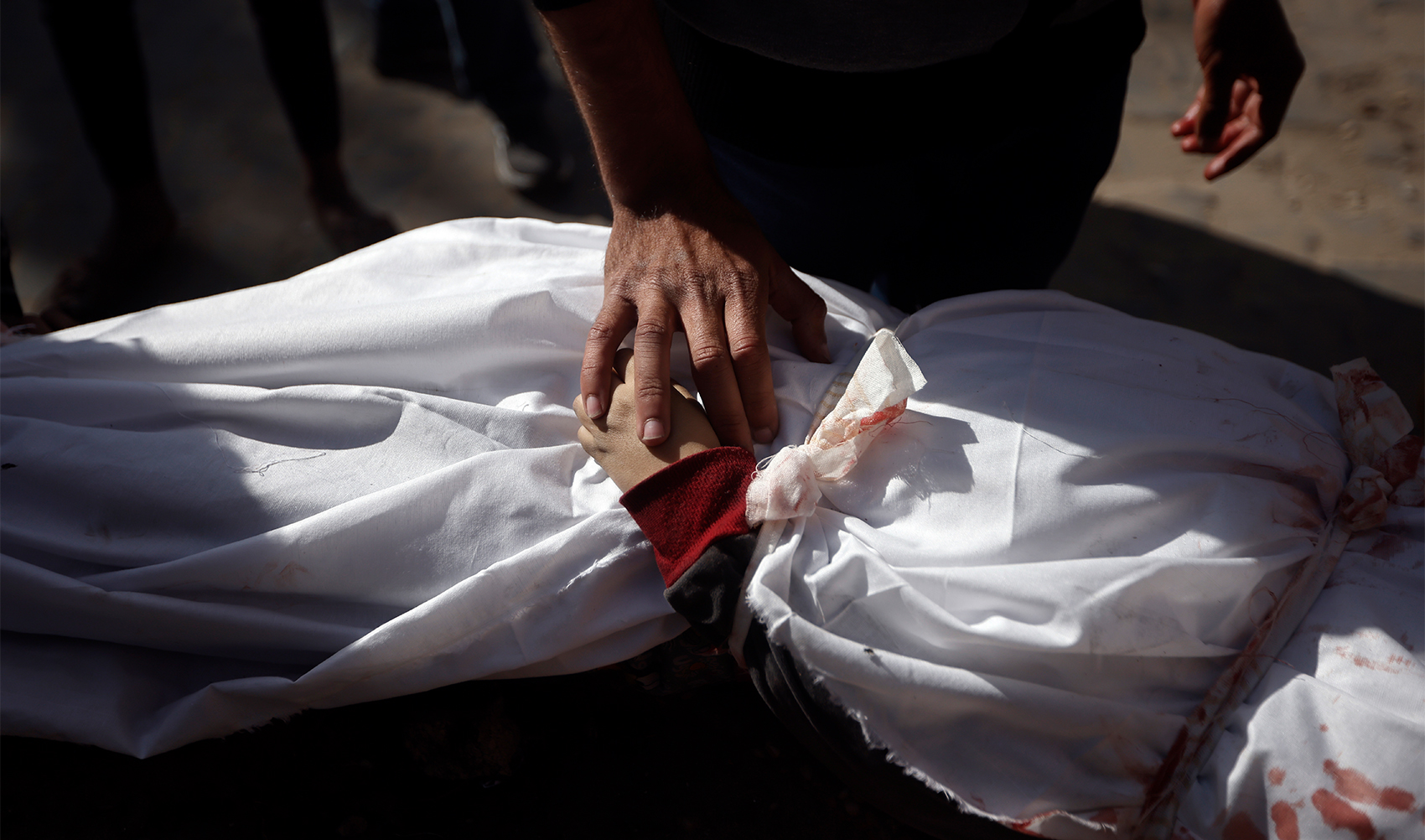 A Palestinian man mourns over the body of a child killed in the Israeli bombardment of the Gaza Strip, at Nasser hospital in Khan Younis, on January 22, 2024. (AP)