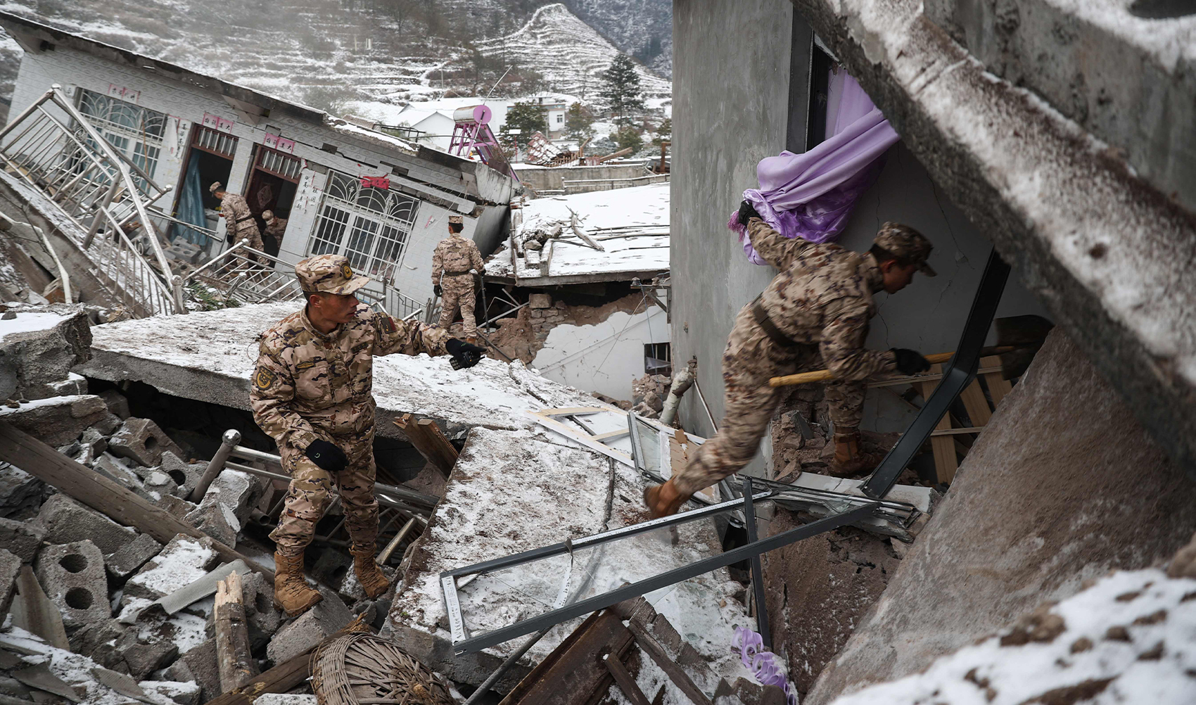 This picture taken on January 22, 2024 shows Chinese military police and rescue workers searching for missing victims at a landslide site in Liangshui village in Zhaotong, in southwestern China's Yunnan province. (AFP)