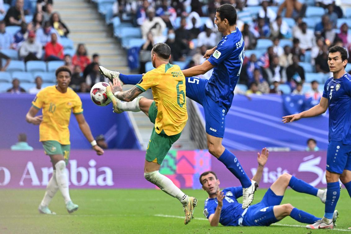 Australia’s forward Martin Boyle competes with Uzbekistan’s defender Umar Eshmurodov during their Qatar 2023 AFC Asian Cup Group B match at Al-Janoub Stadium in Al-Wakrah, on Jan. 23, 2024. (AFP)