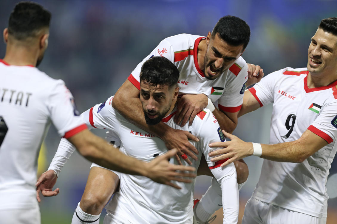 Palestine’s Oday Dabbagh celebrates with teammates after scoring during their Asian Cup Group C match against Hong Kong at Abdullah Bin Khalifa Stadium in Doha on Jan. 23, 2024. (AP)