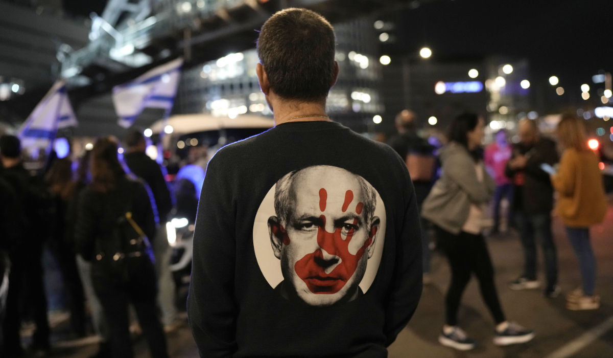 A protester wears a shirt depicting Israeli Prime Minister Benjamin Netanyahu attempt during a demonstration to demand the release of the hostages taken by Hamas militants into the Gaza Strip during the Oct. 7th attack, in Tel Aviv, Israel, Saturday Jan. 20, 2024. (AP)