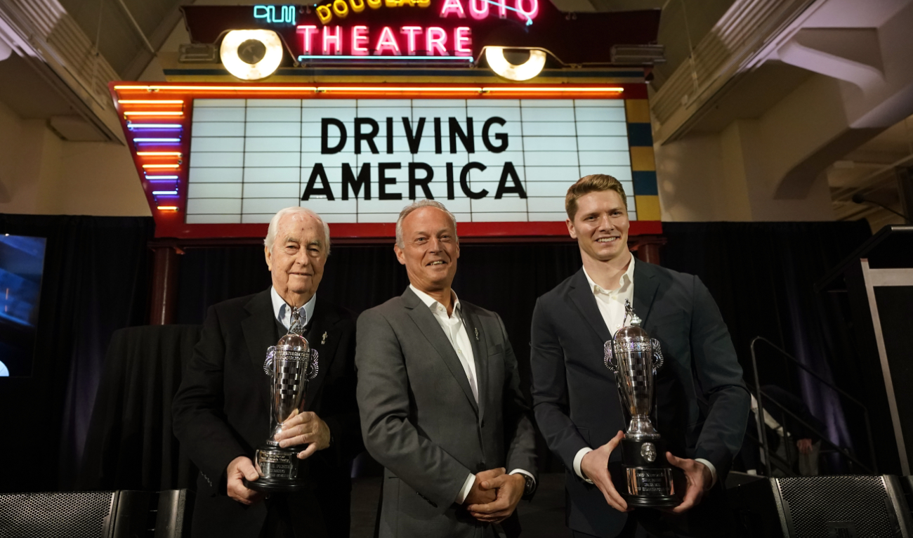 Fred Lissalde, center, president and CEO of BorgWarner; Roger Penske, team owner, left, and driver Josef Newgarden, right, winner of the 2023 Indianapolis 500, hold their Baby Borg driver's and team owner's trophies, Tuesday in Dearborn, Mich. (AP)