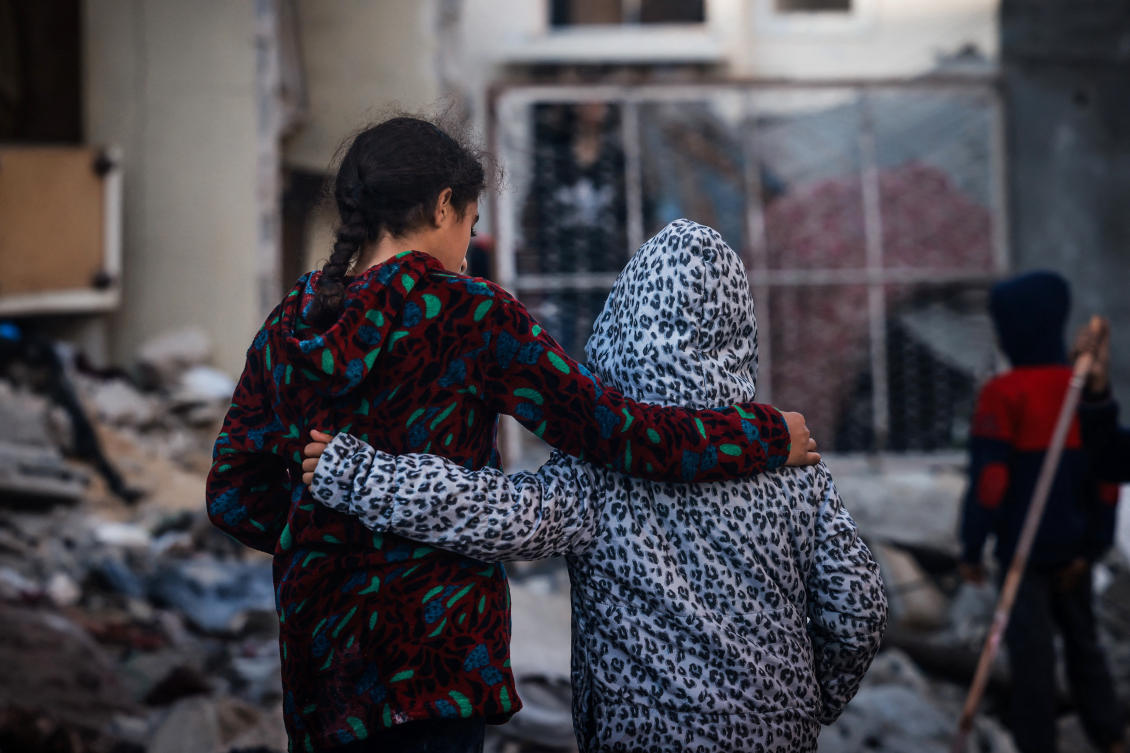Children embrace as people inspect the damage following Israeli bombardment in Rafah on the southern Gaza Strip on December 29, 2023. (File/AFP)