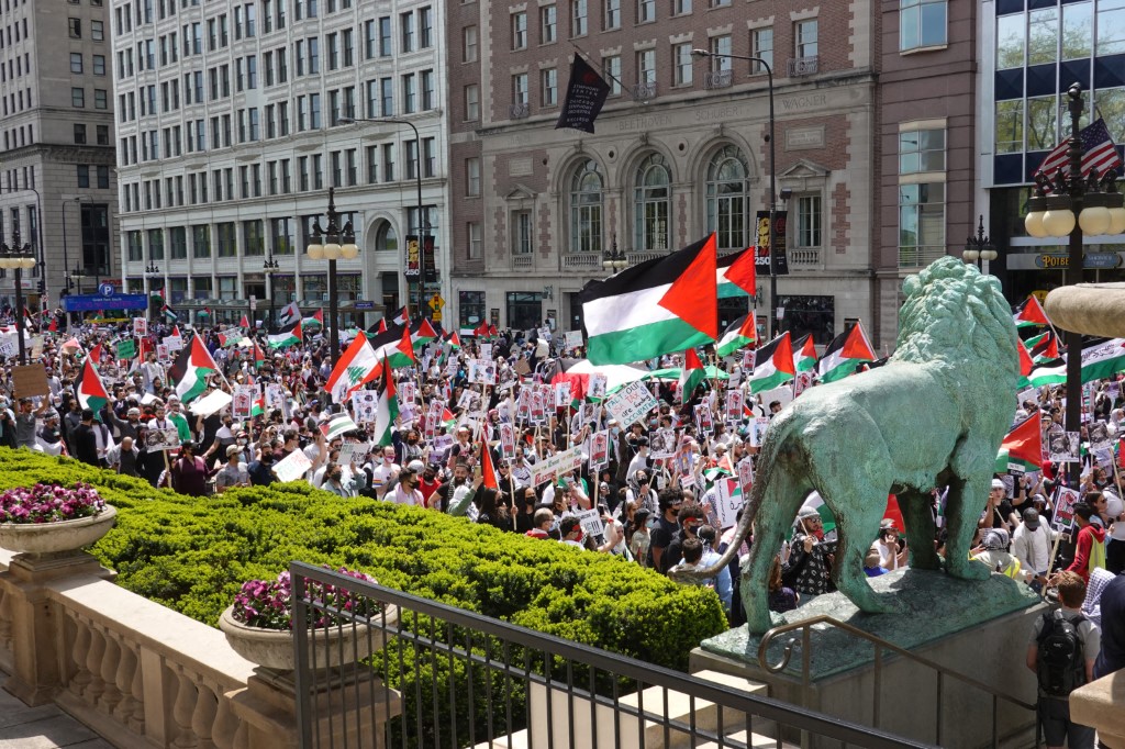 People march through downtown protesting Israeli airstrikes in the Gaza Strip (AFP)