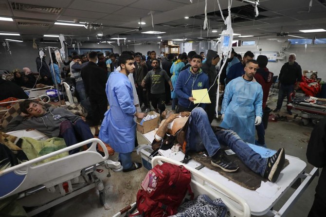 Injured people receive treatment in Gaza City's Al-Shifa hospital, following a reported Israeli strike, that according to Gaza's Health Ministry, killed at least 20 and wounded more than 150 as they waited for humanitarian aid, on January 25, 2024, amid ongoing battles between Israel and Hamas. (AFP)