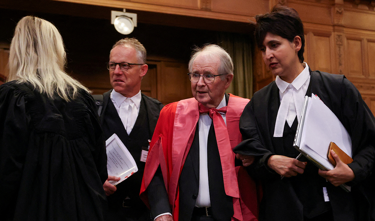 Members of South African legal team Adila Hassim, John Dugard and Max du Plessis stand in the International Court of Justice (ICJ) as judges hear a request for emergency measures by South Africa to order Israel to stop its military actions in Gaza, in The Hague, Netherlands January 12, 2024. (REUTERS)