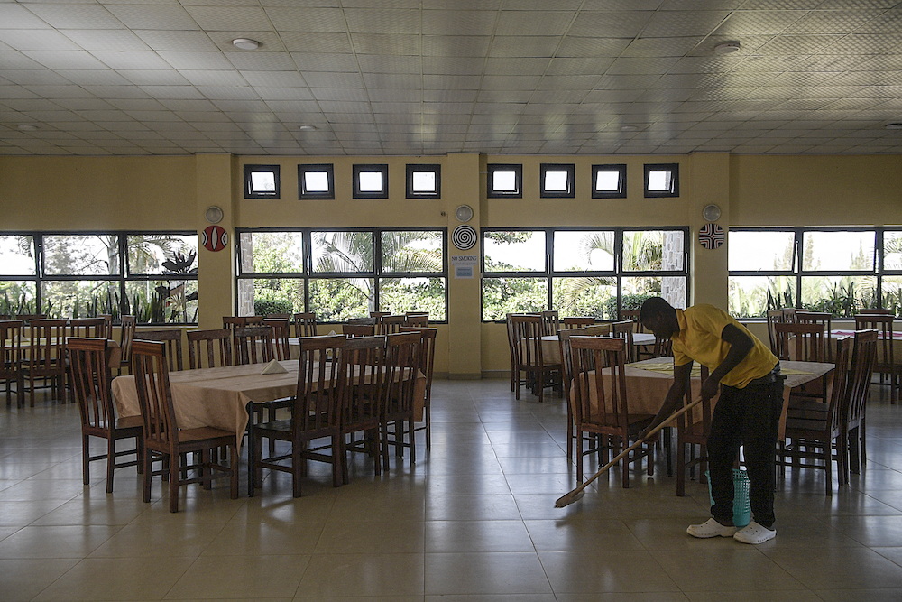 A worker cleans the dining area at Hope Hostel in Kigali, Rwanda, which is getting ready to welcome the migrants from the UK, on June 25, 2022. (AFP)