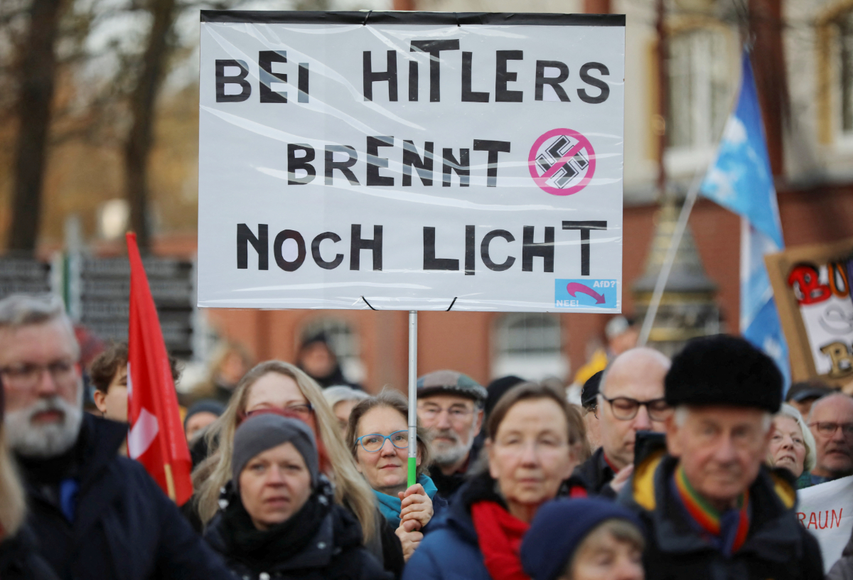 Demonstrators hold a placard reading, "Lights are still on at Hitler's", during a demonstration against the Alternative for Germany party (AfD), right-wing extremism and for the protection of democracy in Eichwalde near Berlin, Germany, January 27, 2024. (REUTERS)